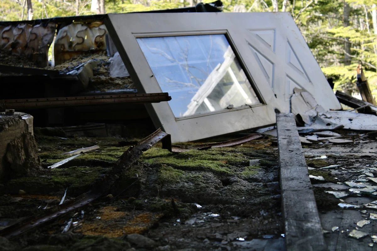 Broken window frame resting on a pile of rubble and debris in Florida
