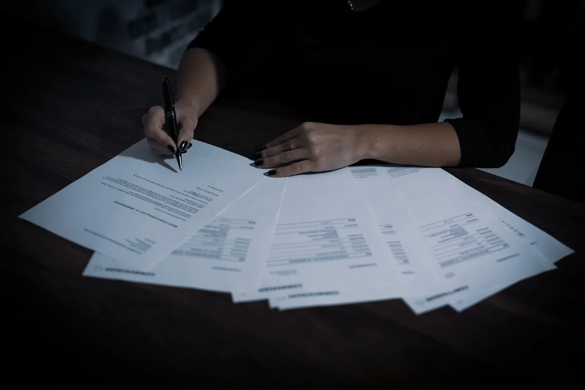Woman signing a real estate contract with a ballpoint pen, Florida property document